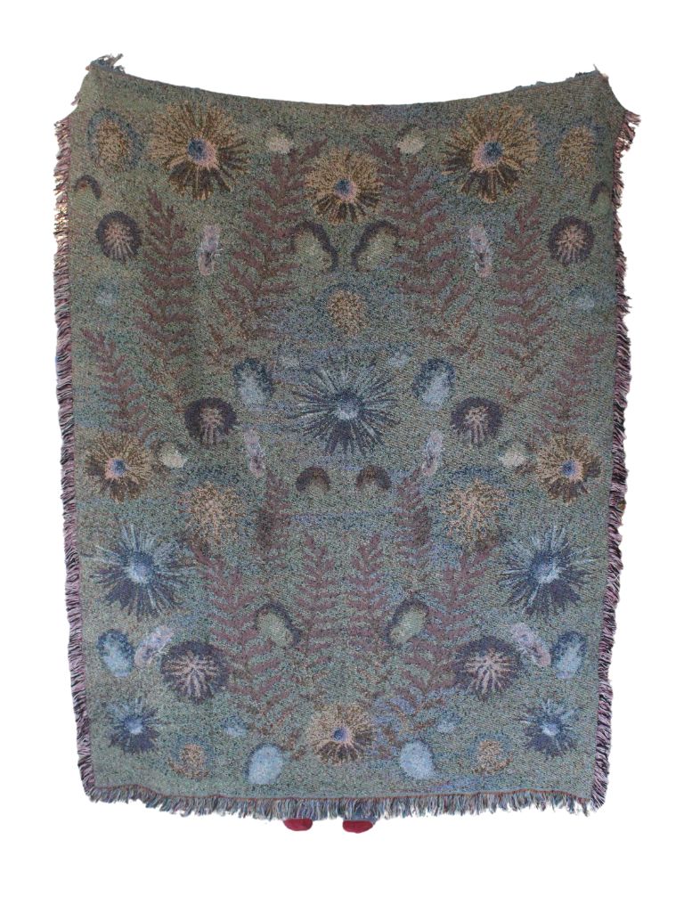 Sonorous Love, Acid Prairie, Floral, boho, throw blanket of prairie pollinator flowers and native bees; reverse colors are mauve, green, blue and white. 100% cotton, made in USA and eco-friendly. Image of a blanket held up with the reverse side facing out.