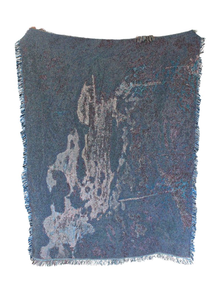 Icebound by John Henry Twachtman, featuring a serene abstract artwork winter scene with curves of ice and snow. eco-friendly cotton woven blanket. Person holding up blanket over a white background. Person holding up the blanket in reverse colors of blue, white and browns