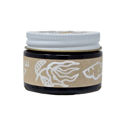 Hand-made herbal medicinal balm with a hand-drawl label of ginger and ylang-ylang essential oils in an amber glass jar. 1oz jar