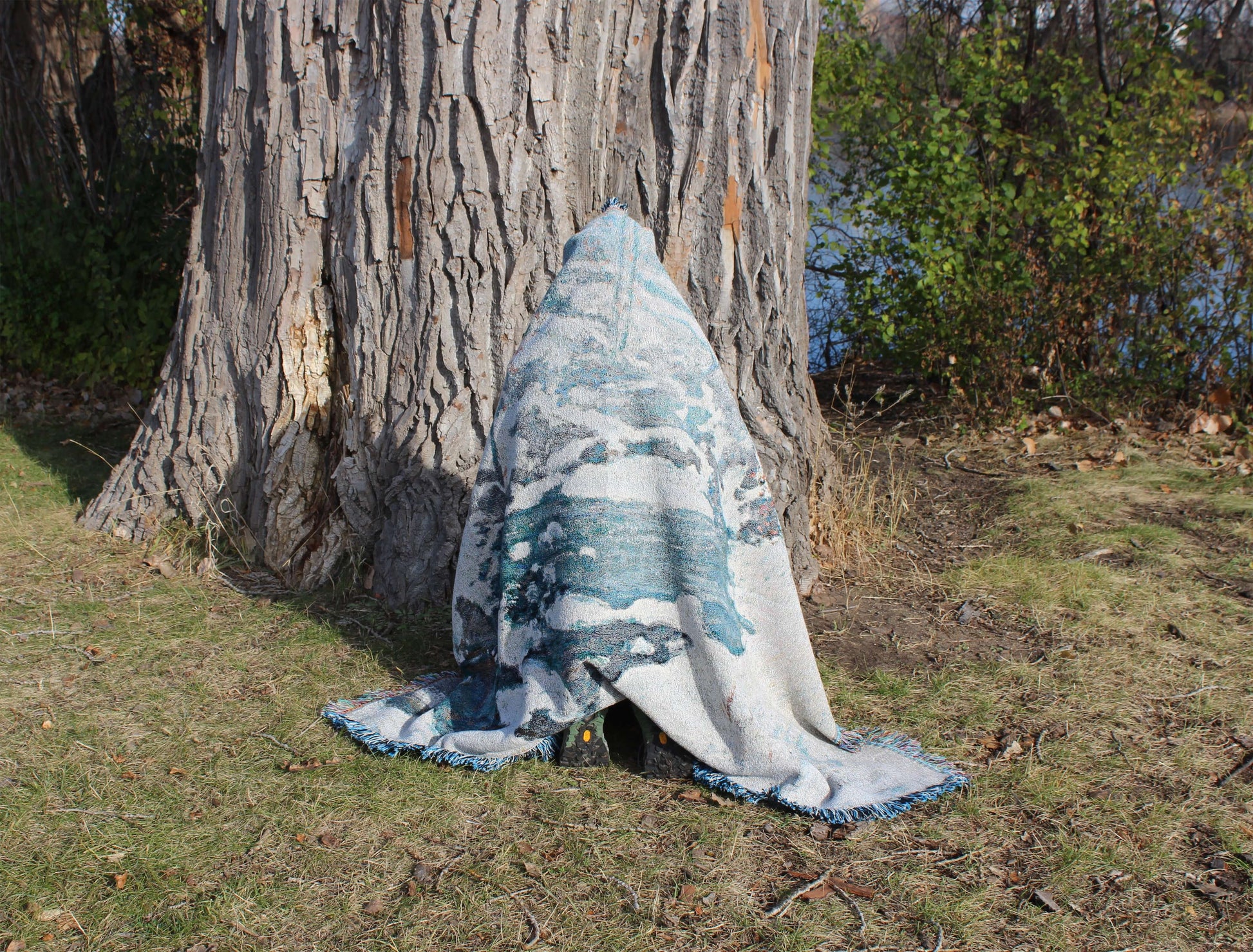 Sonorous Love, Icebound by John Henry Twachtman, featuring a serene abstract artwork winter scene with curves of ice and snow; white, blue and orange leaves. eco-friendly cotton woven blanket