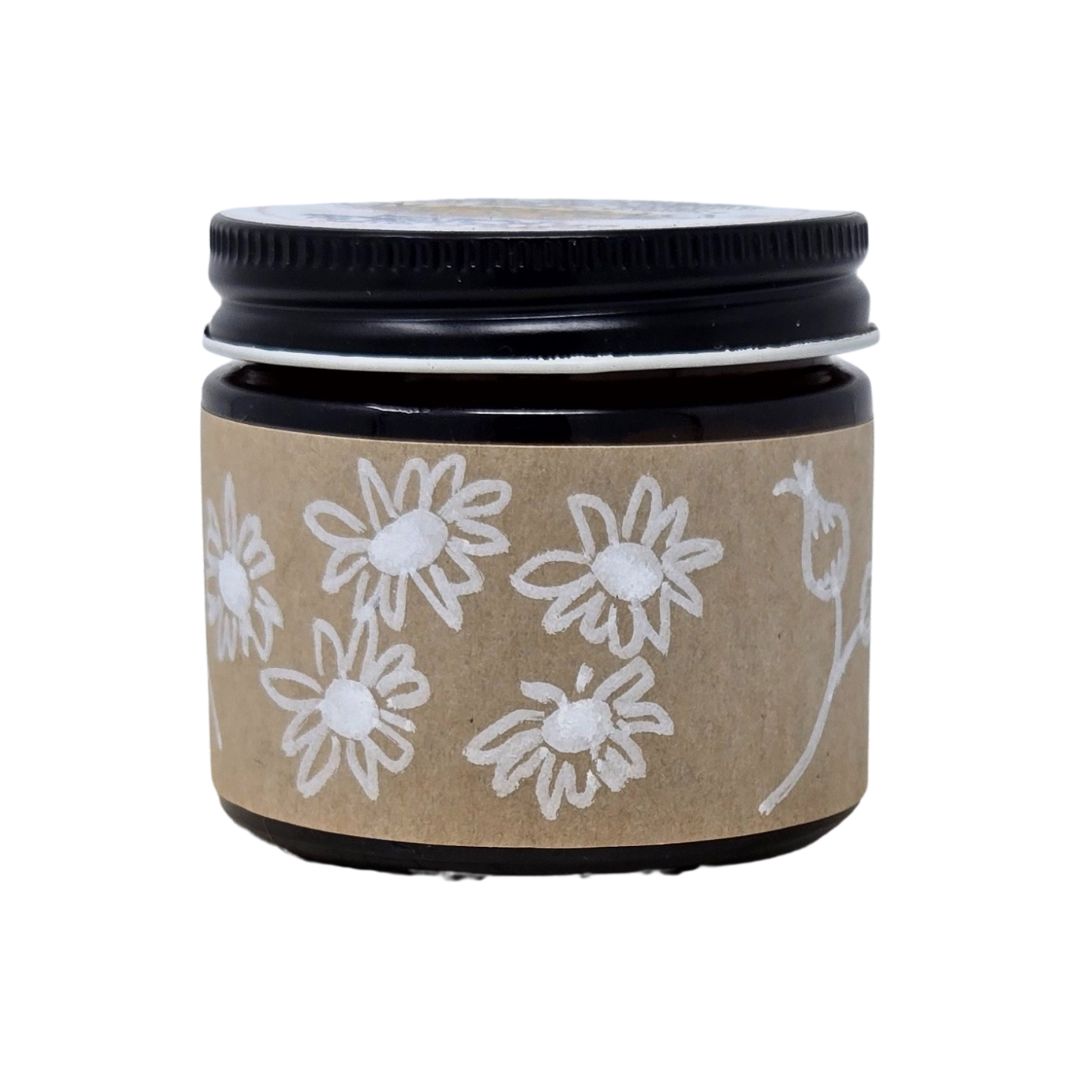 Amber Jar with a black lid and brown label featuring hand-drawn, white floral designs on a white background. 2oz size