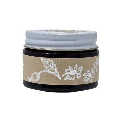 Amber Jar with a black lid and brown label featuring hand-drawn, white floral designs on a white background. 1oz size